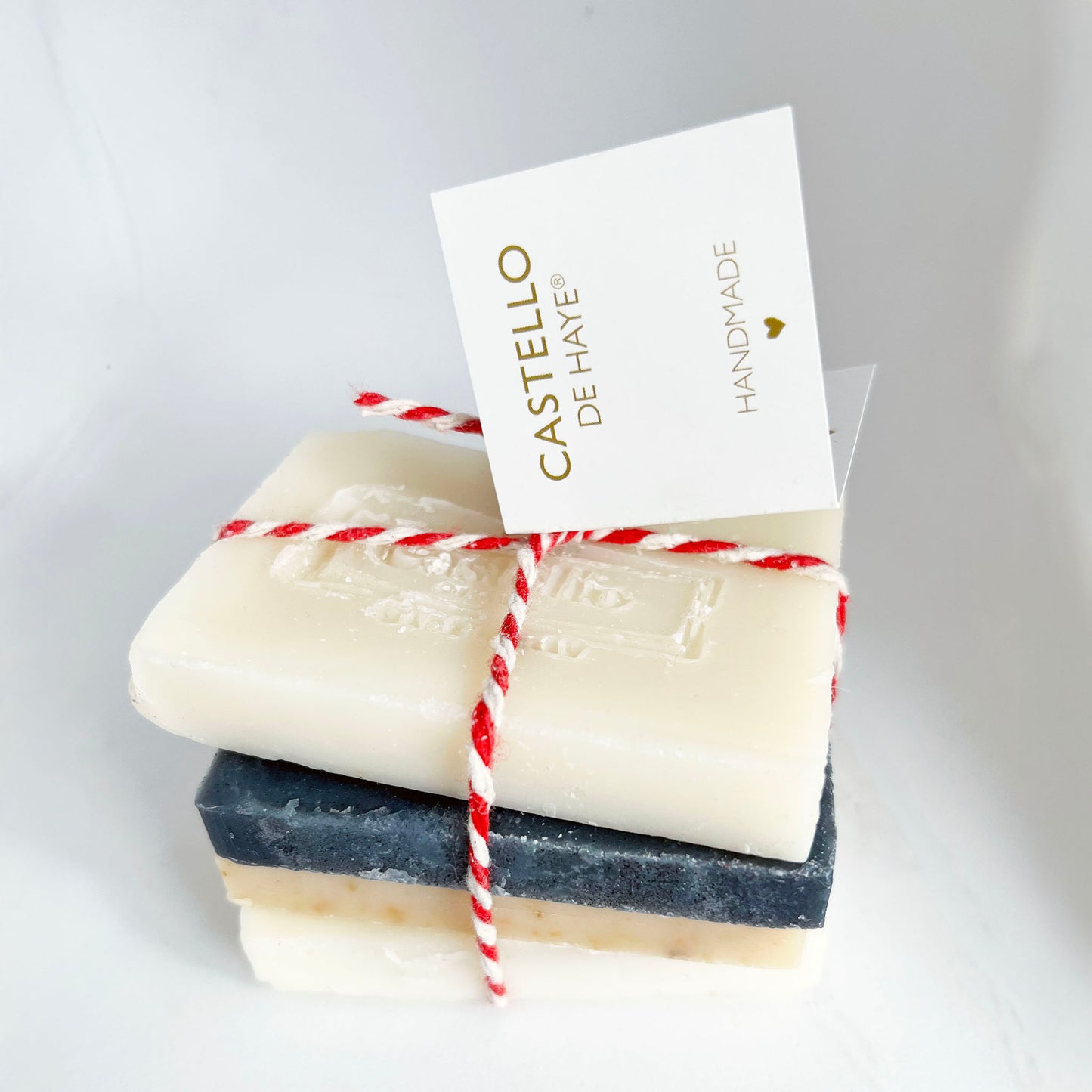 Four bars of soap stacked with a 'Castello de Haye' card on a light gray background