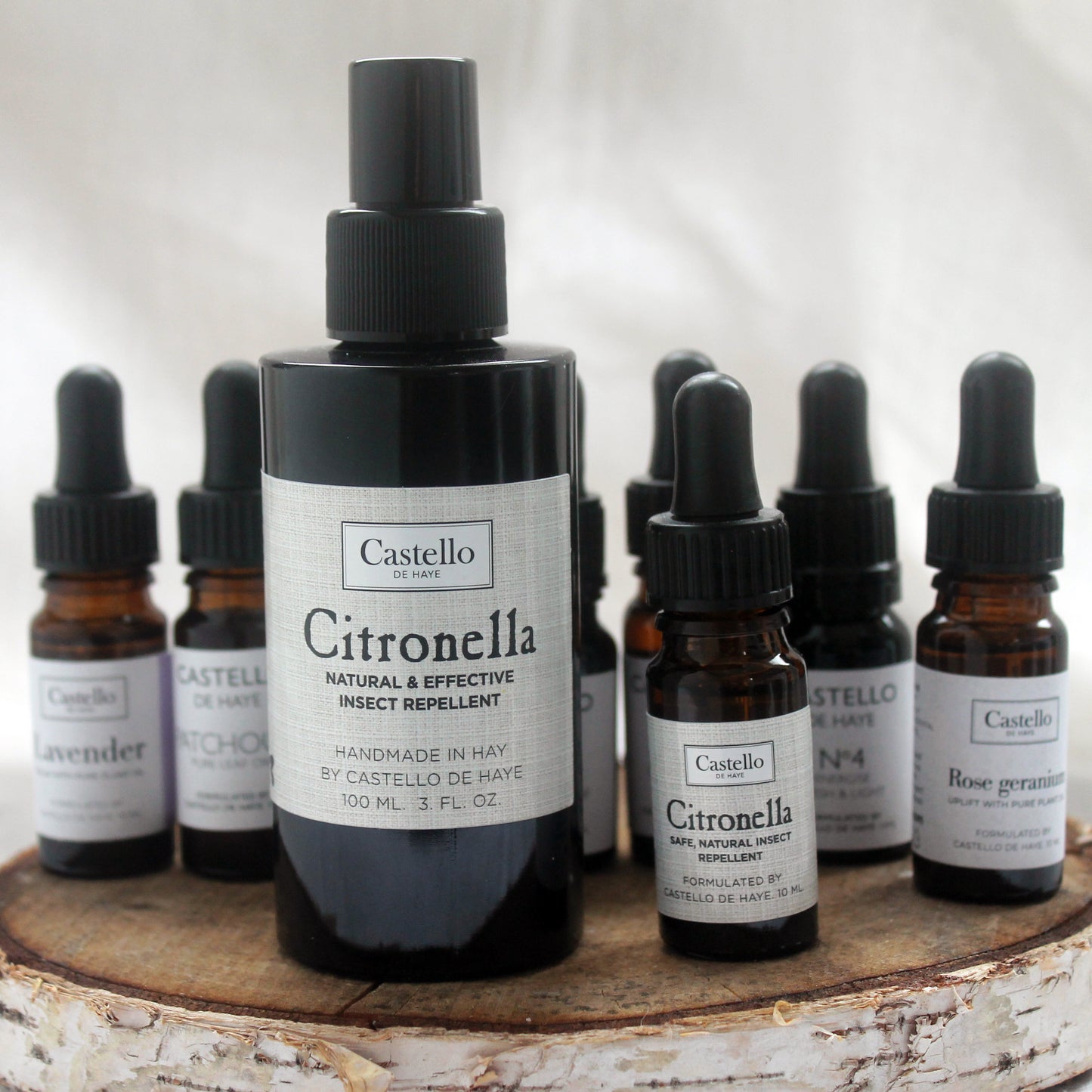 Castello de Haye Aromatherapy bottles on a round wooden tray, Citronella Spray, Citronella oil in the foreground