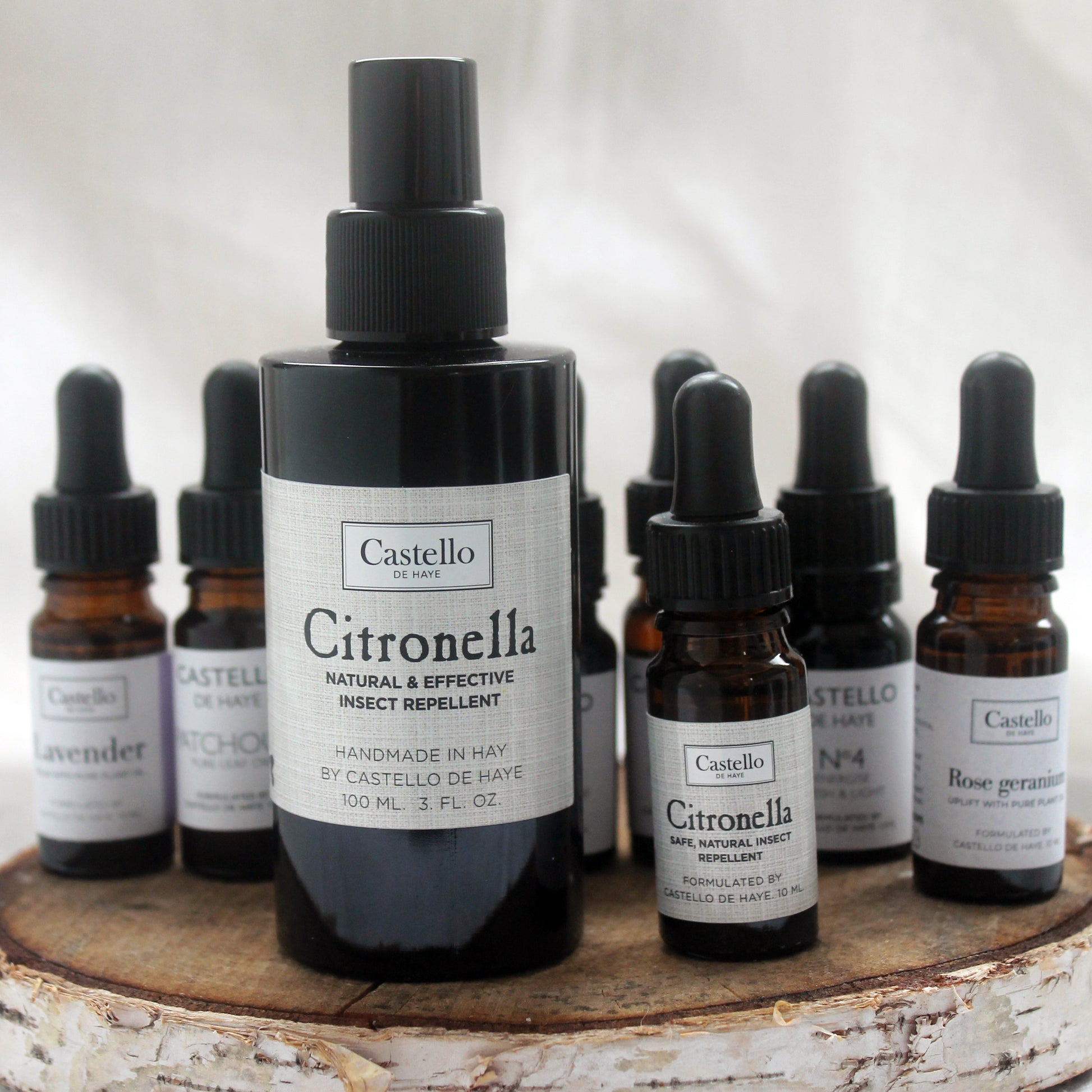 Castello de Haye Aromatherapy bottles on a round wooden tray, Citronella Spray, Citronella oil in the foreground