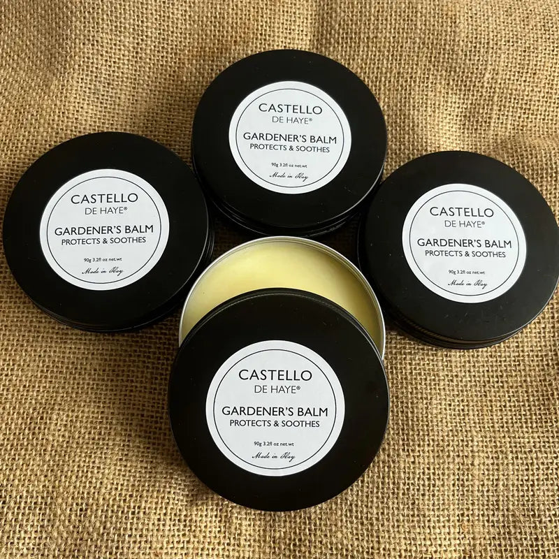 Four containers of Castello de Haye Gardener's Balm on a burlap background