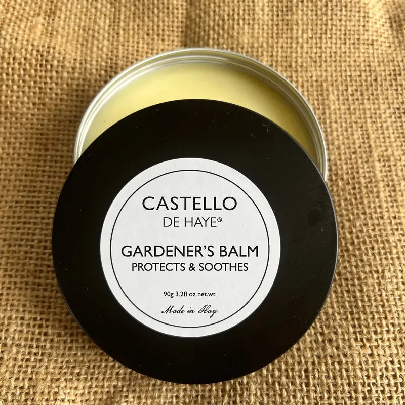 Jar of Castello de Haye Gardener's Balm on a burlap background