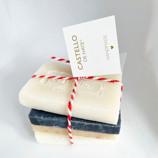 Four bars of soap stacked with a 'Castello de Haye' card on a light gray background